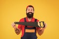 Handsome smiling man happy with saw yellow background. Gardener lumberjack equipment. Tools shop. Sharp blade of saw