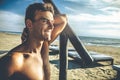 Handsome smiling man outdoor on the beach at the sea Royalty Free Stock Photo