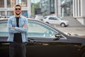 Handsome smiling man standing in front of car Royalty Free Stock Photo