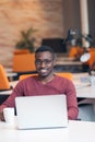 Handsome smiling successful African American man using laptop computer Royalty Free Stock Photo