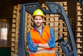 Handsome smiling worker driving forklift in warehouse. Woodworking industry concept. Royalty Free Stock Photo