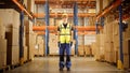 Handsome Smiling Worker Wearing Hard Hat and Safety Goggles Standing in the Retail Warehouse full Royalty Free Stock Photo