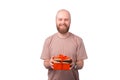 Handsome smiling young bearded man holding gift box over white background Royalty Free Stock Photo
