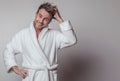 Handsome smiling young man in luxurious bathrobe. Royalty Free Stock Photo