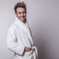 Handsome smiling young man in luxurious bathrobe. Royalty Free Stock Photo