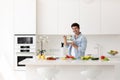 Handsome smiling young man with plate of salad fresh vegetables looking at camera Royalty Free Stock Photo