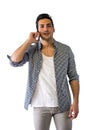 Handsome young man talking on cell phone, smiling Royalty Free Stock Photo