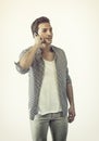 Handsome young man talking on cell phone, smiling Royalty Free Stock Photo