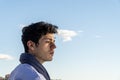 Handsome Spanish young man looking at something with a serious face Royalty Free Stock Photo