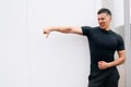 A handsome sports coach shows his indignation at a white background