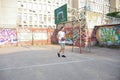 Handsome sports guy on the court plays basketball training