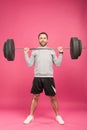 handsome sportsman exercising with barbell, isolated