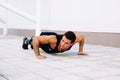 Handsome sportsman practicing pushs up outdoors