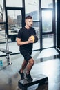 handsome sportsman training on step platform with medicine ball