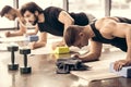 handsome sportsmen simultaneously doing plank and using blocks Royalty Free Stock Photo