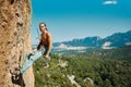 Handsome sporty man rock climber hanging on rope and looking to camera., resting before climbing Royalty Free Stock Photo