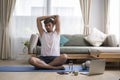 Handsome sporty man stretching arms during morning workout at home. Sport, fitness and healthy lifestyle concept Royalty Free Stock Photo