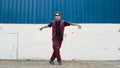 Handsome street dancer practicing break dancing at white back ground. Endeavor. Royalty Free Stock Photo