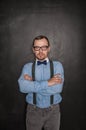 Handsome strict teacher in eyeglasses looking at you on blackboard Royalty Free Stock Photo