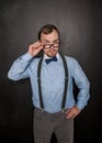 Handsome strict teacher in eyeglasses looking at you on blackboard Royalty Free Stock Photo