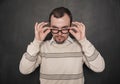 Handsome strict teacher in eyeglasses looking at you on blackboard Royalty Free Stock Photo