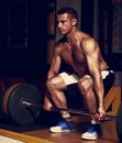 Handsome strong man lifting barbell in crossfit gym and lookin s Royalty Free Stock Photo