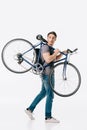 handsome student holding bicycle on shoulder