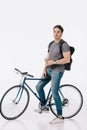 handsome student sitting on bicycle and holding coffee to go