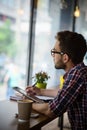 Handsome student studying in restaurant Royalty Free Stock Photo