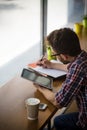 Handsome student studying in restaurant Royalty Free Stock Photo