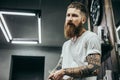 Close up of young bearded barber sitting and talking