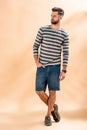 Handsome stylish bearded man posing in striped sweatshirt Royalty Free Stock Photo