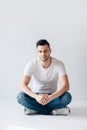 Handsome stylish man portrait sitting on floor