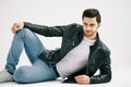 Handsome stylish man posing lying on floor over white studio background. Royalty Free Stock Photo