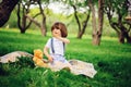 Handsome stylish 3 years old toddler child boy with funny face in suspenders enjoying sweets on picnic Royalty Free Stock Photo