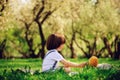 Handsome stylish 3 years old toddler child boy with funny face in suspenders enjoying sweets on picnic in spring Royalty Free Stock Photo