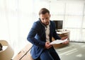 Handsome stylish young entrepreneur, prosperous businessman, successful CFO in business suit, talking on landline phone stack of Royalty Free Stock Photo