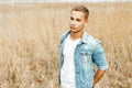 Handsome stylish young man in a jeans jacket and a white shirt Royalty Free Stock Photo