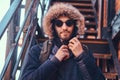 A handsome stylish young man sitting on stairs outside. Royalty Free Stock Photo