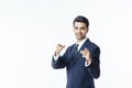 Handsome successful businessman in black suit and tie pointing at camera with two fingers Royalty Free Stock Photo