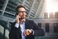 Business man stand at street holding a smartphone in office park Royalty Free Stock Photo