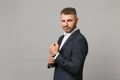 Handsome successful confident young business man in classic black suit shirt posing isolated on grey wall background Royalty Free Stock Photo