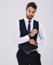 Handsome and successful. Studio shot of a well-dressed man against a gray background. Royalty Free Stock Photo