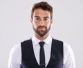 Handsome and successful. Studio shot of a well-dressed man against a gray background. Royalty Free Stock Photo