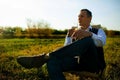 Successful Stylish Mid Adult Man Drinking Wine In Green Field.