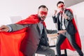 handsome super businessmen in masks and capes having fun