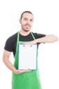 Handsome supermarket employee holding and showing clipboard Royalty Free Stock Photo