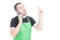 Handsome supermarket employee making great idea gesture at phone