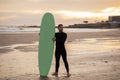 Handsome Surfer Man With His Surfboard Standing On The Beach At Sunset Royalty Free Stock Photo