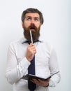 Handsome surprised man with pen and notebook in hands, on white background.